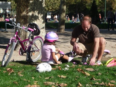 A rollerblading lesson taking place at the kid-friendly Champ de Mars, part of local Paris that can be found in the shadow of the Eiffel Tower