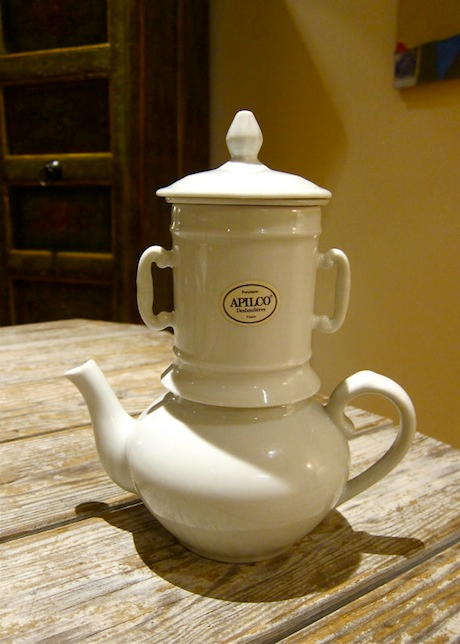 A demure white classic teapot