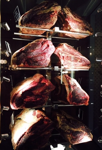 Aging beef in cold cases as you are walking in