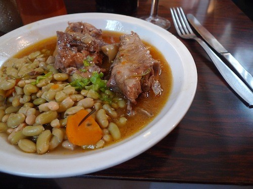 Sautéed lamb with white beans is among the traditional fare on the menu at Le Rubis, in the 1st Arrondissement, in Paris