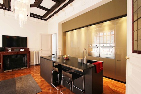 The modern, large kitchen of an apartment in Paris that is on the real-estate market